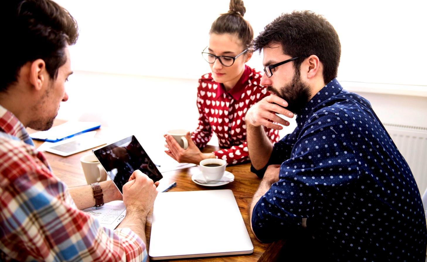 Professional investment consultation meeting with financial documents and charts